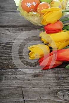 Bouquet of yellow and red tulips and easter eggs