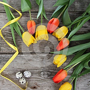 Bouquet of yellow and red tulips and easter eggs