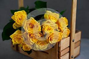 Bouquet of yellow roses on a gray background
