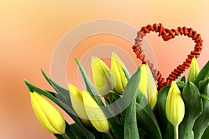 Bouquet of yellow tulips flowers with ratan heart