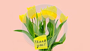 Bouquet of yellow tulips in a vase and the inscription Thank you.
