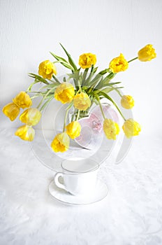 Bouquet of yellow tulips vase on the table