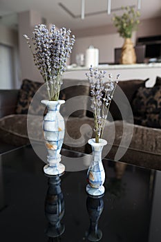 Bouquets of aromatic dried lavender or lavandin flowers in beautiful vases