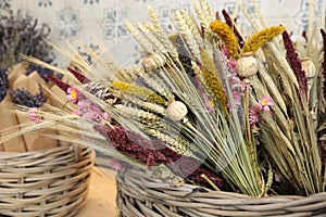 Bouquets of beautiful dried flowers plants - chrysanthemums, lavender, poppies, wheat spikelets in the greek flowers bar.