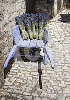 Bouquets of dry french lavender flowers in a wooden cart.