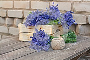 Bouquets of lavender in wooden box and a coil of rope