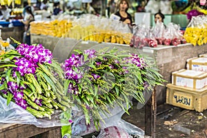 Bouquets of purple and white orchid flowers stacked on display a