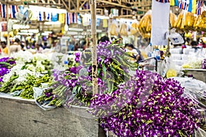 Bouquets of purple and white orchid flowers stacked on display a