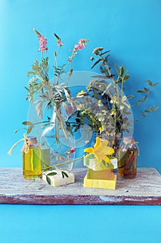 Bouquets of useful herbs and flowers, natural soap, aromatic oil