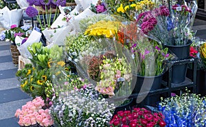 Bouquets of various flowers are sold in a flower shop