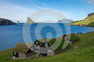 Bour village. Typical grass-roof houses and green mountains. Vagar island, Faroe Islands. Denmark. Europe photo