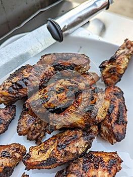 Bourbon and brown sugar marinated wings in blackened seasoning