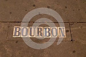 Bourbon Street plaque embedded in the sidewalk