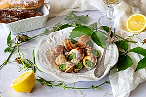 Bourguignonne snail with lemon. Marble background. French cuisine