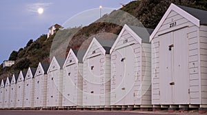 White colour beach huts located on the promenade facing the sea on the Bournemouth UK sea front.