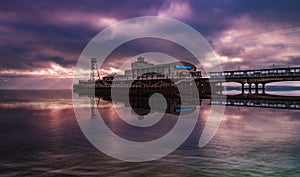 Bournemouth pier illuminated by the setting sun at sunset