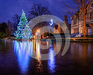 Bourton on the water christmas tree in the river Windrush before sunrise
