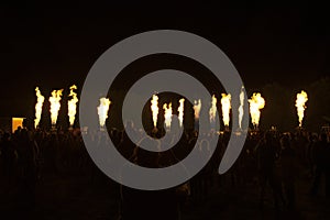 Bousov castle Czech Rep August 19th 2017 People with cellphones wath the public fire show of hot air balloons lined up