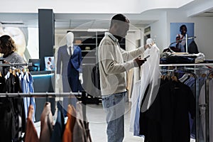 Boutique customer examining garment