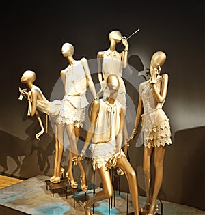 Boutique display window with mannequins.