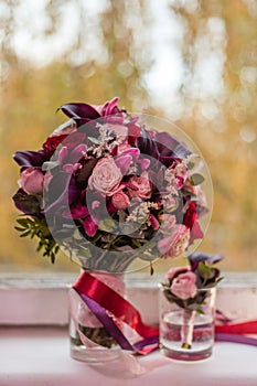 Boutonniere and the bride`s bouquet