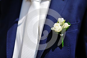 Boutonniere flower on jacket of wedding groom