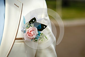 Boutonniere of Rose on a White Fashionable Wedding Suit of Groom at Sunny Day Outdoors