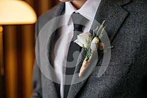 Boutonniere on the suit of the groom, closeup