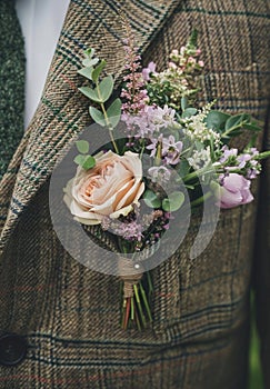 Boutonniere on tweed jacket. Close-up shot with selective focus