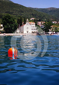 A bouy floating in the sea close to the Church of Saint Spyridon in Djenovici, Montenegro