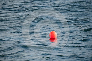 A bouy in the sea marking the location of fishing nets