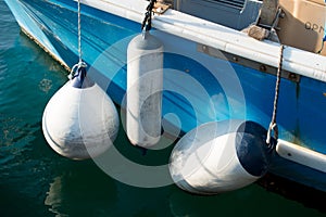 Bouys on the side of a small fishing boat.