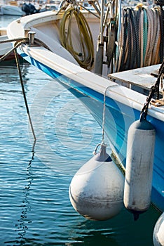 Bouys on the side of a small fishing boat.