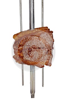 Bovine rump meat steak, traditional brazilian barbecue whole piece on skewer, on white background