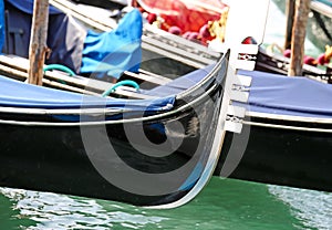 bow of the boat to transport tourists to Venice in Italy called Gondola moored