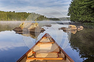 Bow of canoe on a lake in early morning - Ontario, Canada