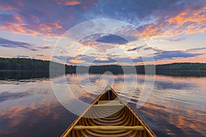 Bow of a cedar canoe on a lake at sunset - Ontario, Canada