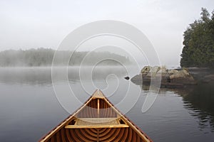 Bow of a Cedar Canoe on a Misty Lake