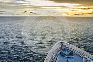 Bow of cruise ship in ocean at sunset