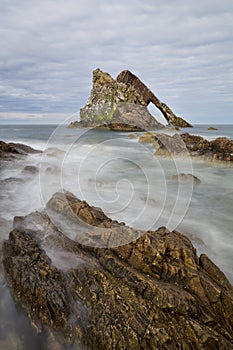 Bow-fidle Rock landscape on the coast of Scotland on cloudy afternoon