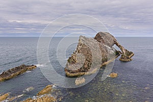 Bow-fidle Rock landscape on the coast of Scotland on cloudy afternoon