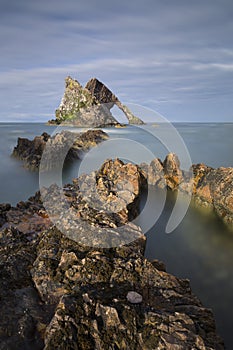 Bow-fidle Rock landscape on the coast of Scotland on cloudy afternoon
