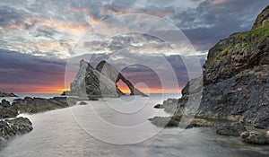 Bow-fidle Rock sunrise landscape on the coast of Scotland on cloudy morning