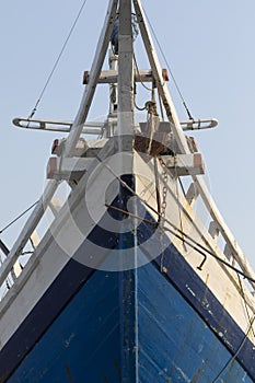 The bow of a huge old wooden boat in the port of the city of Jakarta