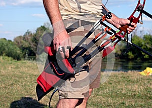 Bow hunter hands holding compound bow