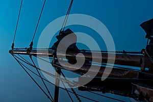 Bow of an old wooden tall ship in the morning mist