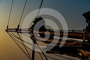 Bow of an old wooden tall ship in the morning mist