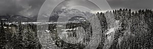 The Bow river winds through a snowy forest in Canmore, Canada