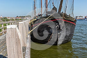 Bow sailing ship moored at pier of Dutch village Urk