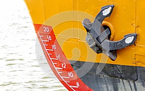 Bow of a ship with draft scale numbering and anchor